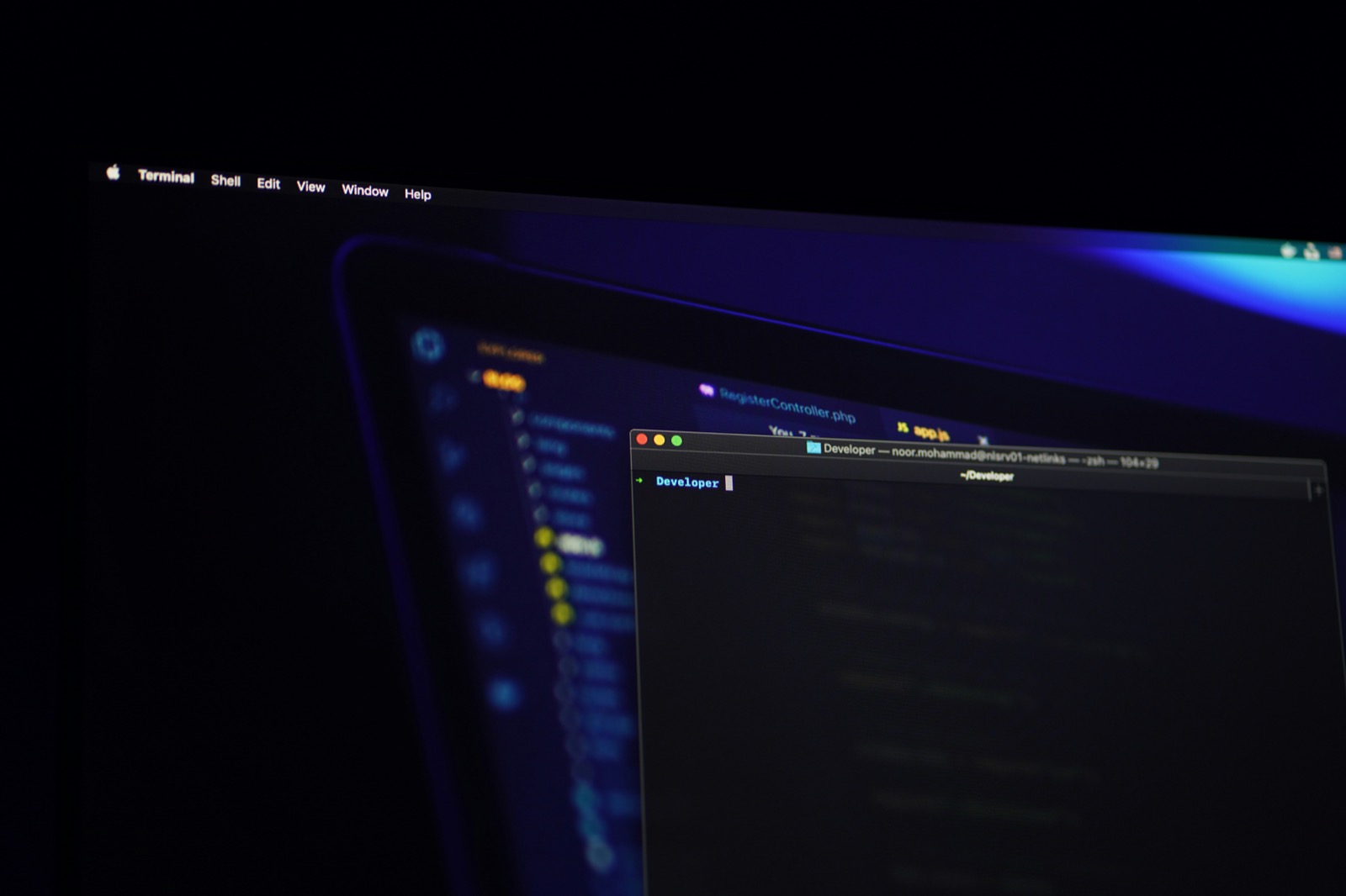 Dark monitor displaying code with blue ambient lighting