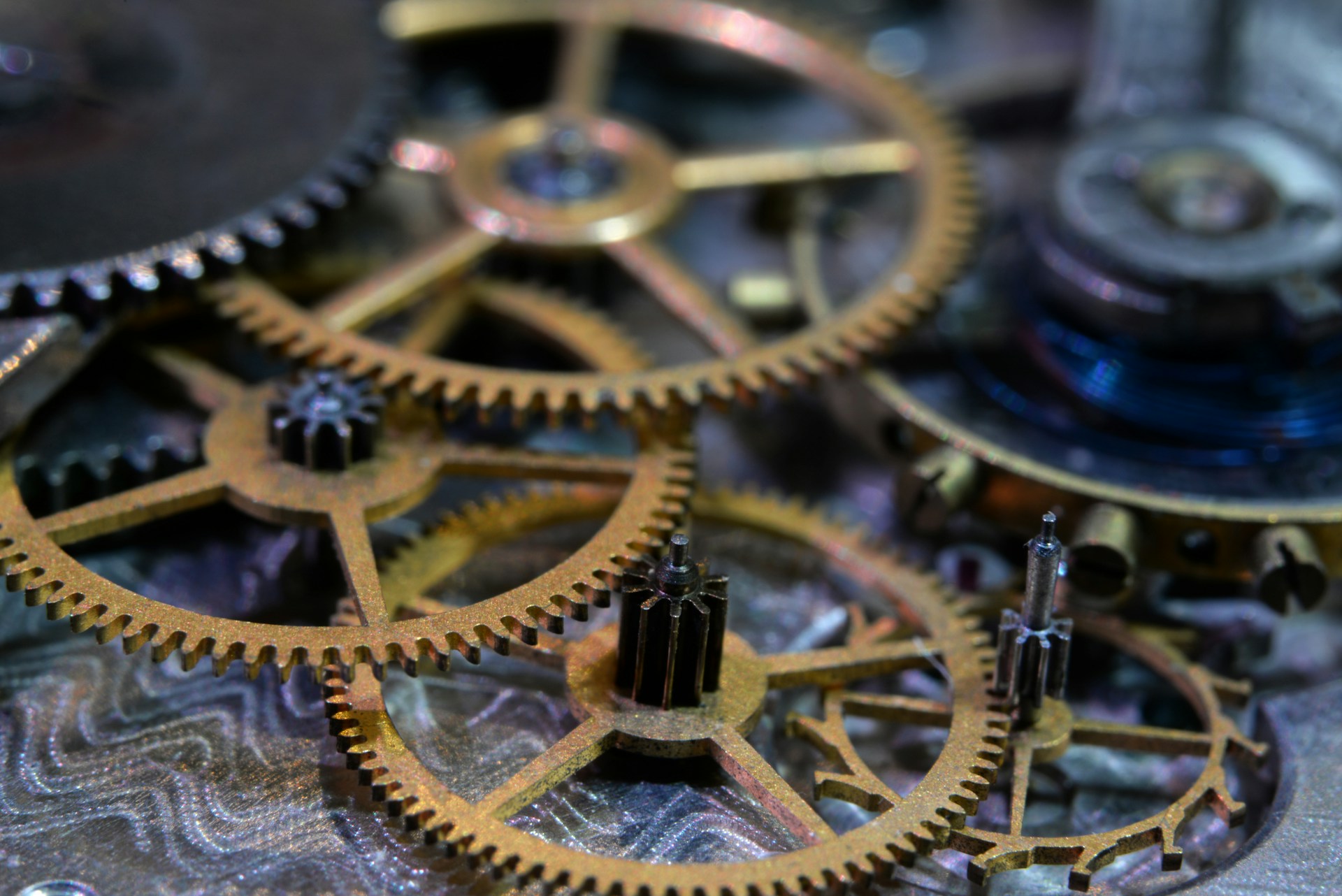 Macro close-up of interlocking brass clockwork gears, warm tones, shallow depth of field