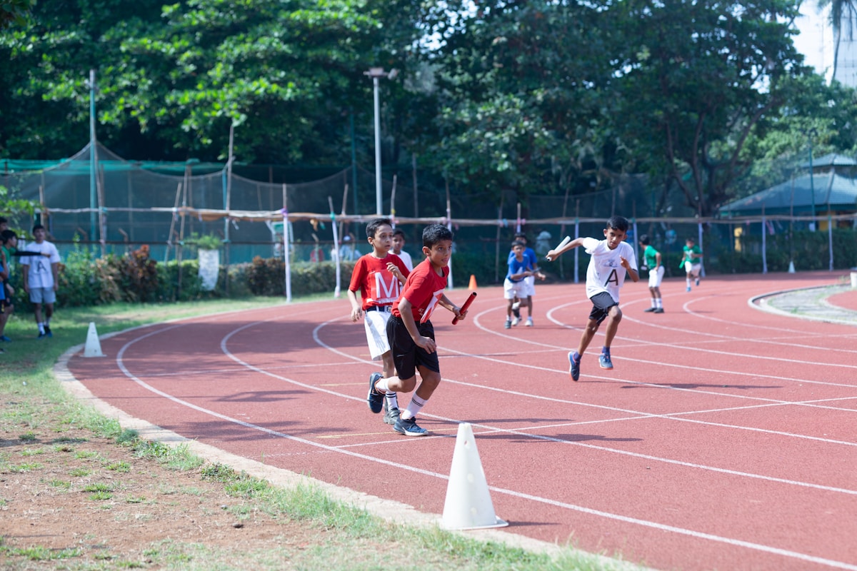 Kids running on an athletics track during a training session